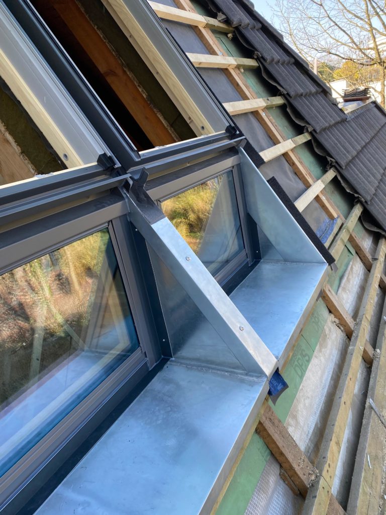 Man sieht ein Steildach eines Hauses mit neuen Dachfenstern, passgerecht eingesetzt durch Firstetage Leverkusen.